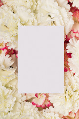 Paper copy space on white carnations