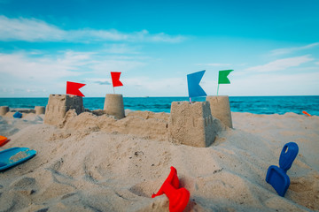 Sand castle on beach vacation and toys