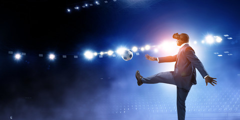 Fototapeta na wymiar Black businessman on virtual reality football match