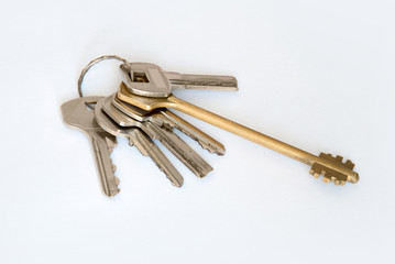 A bunch of modern door keys on ring on white background
