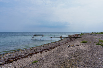 Fototapeta na wymiar Footbridge on the coast with sandy beach and wide view over the Baltic Sea