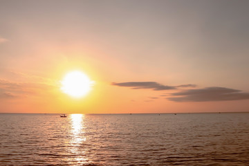 Beautiful dramatic atmosphere of twilight sky and sea with fisherman's boats in summer tropical season.