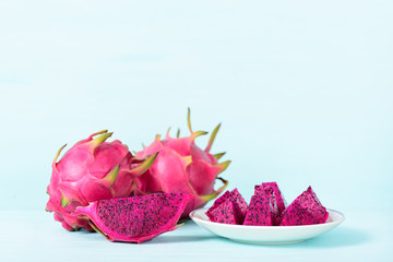 Red dragon fruit or pitaya on pastel background with copy space