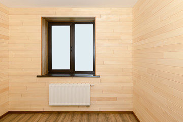 Interior of a living room with a wooden window and walls