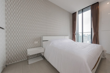 Interior of modern bedroom with cozy double bed