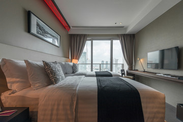 Interior of modern bedroom with cozy double bed