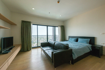 Interior of modern bedroom with cozy double bed