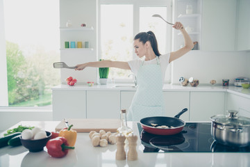 Photo of glad joyful fighting girlfriend seeing her ex coming into your house while frying mushrooms