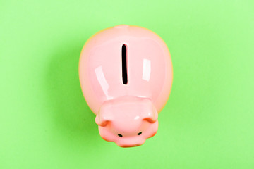 income management. planning budget. financial problem. piggy bank on green background. money saving. top view of money box. empty moneybox. moneybox with slot. you have nothing
