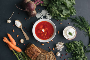The main ingredients - vegetables for cooking borsch (beetroot, cabbage, carrots, potatoes, tomatoes). Top view.