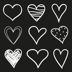 Hand drawn abstract hearts on black background. Sketchy elements for design. Black and white illustration