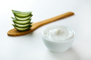 Minimalistic composition of sliced aloe vera leaves, for making moisturizing skincare gel. Organic home made cosmetics concept. Close up, copy space, top view, flat lay.