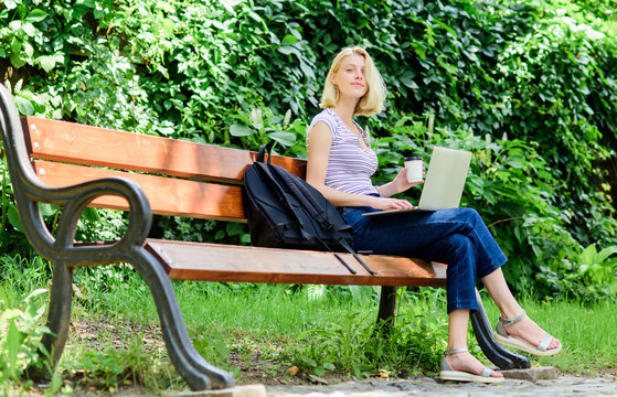 Surfing internet. Modern student life. Regular student. Girl adorable student with laptop and coffee cup sit bench in park. Study outdoors. Woman student work with notebook. Learn study explore