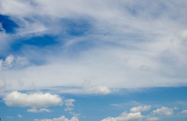 Naklejka na ściany i meble Beautiful white clouds on blue sky on a sunny day