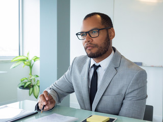 Focused business professional listening to speaker during meeting or conference. Businessman...