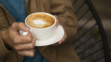 Close-up of man holding coffee cup