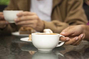 Close-up of woman holding coffee cup
