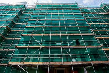 Professional scaffolding on the side of a building under renovation.