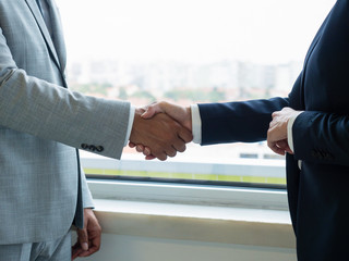 Male and female partners closing deal or agreement. Closeup os business man and woman shaking hands...