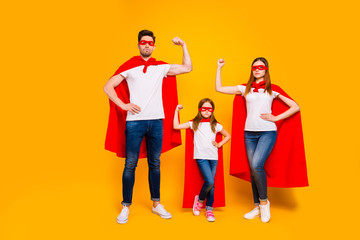 Family of three members playing cartoon incredible characters wear superhero costume isolated...