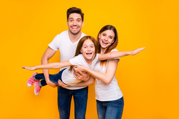 Photo of three family members spending leisure time playing games wear casual outfit isolated yellow background