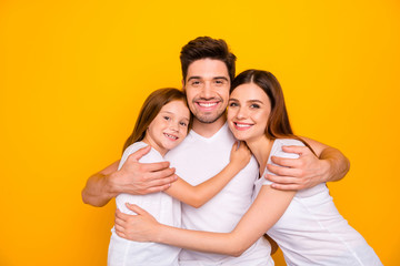 Photo of three family members hugging happy together wear casual outfit isolated yellow background