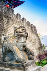 Ancient guardian lion and Chinese Architecture. Located in North Gate of Dali Old Town, Dali,...