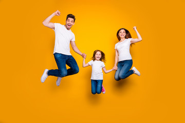 Fototapeta na wymiar Full length body size view of three nice attractive slim sporty lovely cheerful cheery person having fun rejoicing holding hands achievement success isolated over bright vivid shine yellow background