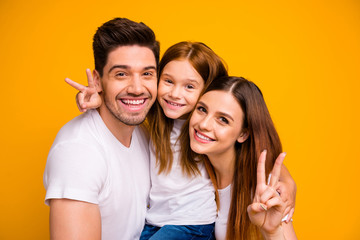 Close-up portrait of three nice attractive charming cute lovely cheerful cheery optimistic person spending weekend showing v-sign isolated over bright vivid shine yellow background