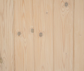 Background. Wooden boards are painted in light beige with gray spots of knots.