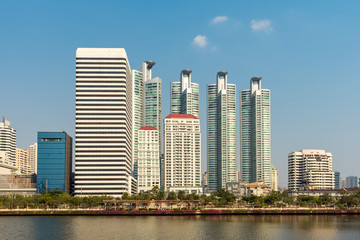 Fototapeta na wymiar Skyscraper, office blocks and condominium at the Benjakitti Park in the Khlong Toei district of the metropolis Bangkok. The urban Park was a former industrial area, opened in 2004