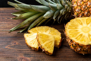 Pineapple on dark wooden background.