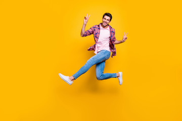 Fototapeta na wymiar Full length body size photo of man running on air showing you v-sign in order to say hi while isolated with yellow background