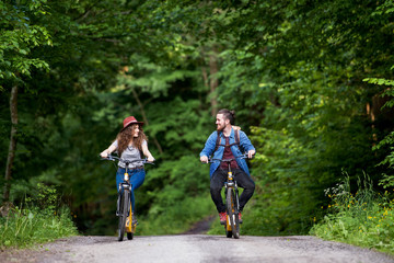 Fototapeta premium Young tourist couple travellers with electric scooters in nature.