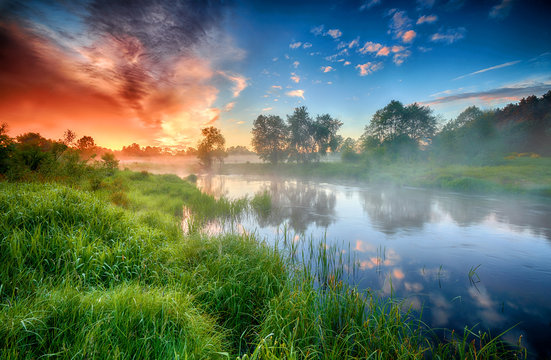 Beautiful summer sunrise over river banks © Piotr Krzeslak