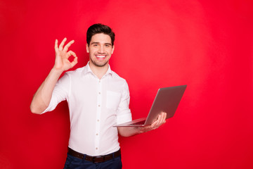 Photo of excited cheerful funny funky man showing you ok sign while isolated with red background