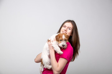 Pretty girl with terrier puppy. Studio image