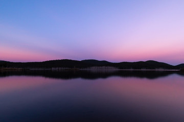 A perfect reflection during a pink sunset a lake on a clear and sunny day in Queensland, Australia