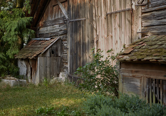 Fototapeta na wymiar Old rustic wooden barn in rural garden during summer