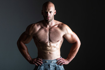 Fototapeta na wymiar Brutal strong athletic bodybuilding men posing in studio. Bodybuilding and healty life concept 