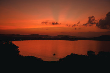 Scenic sunrise view at Merese hill, Lombok island, Indonesia.Beautiful golden sunset/sunrise over the sea behind mountains in background