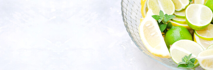 A banner for a site with a dish of sliced lemons and limes.