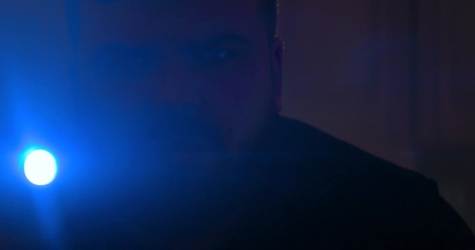 The man with a flashlight walking. anamorphic lens shot closeup, 4k