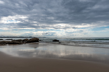 Grey clouds loom on Rainbow Bay overlooking the Gold Coast cityscape on cloudy day in Australia.