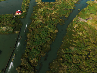 Floating garden in Inle Lake, Myanmar, Burma.Locals transporting goods on a small boat through a floating village on the Inle lake, Myanmar