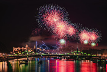 Fototapeta premium Colorful red and blue fireworks over Budapest, River Danube with bridges, night