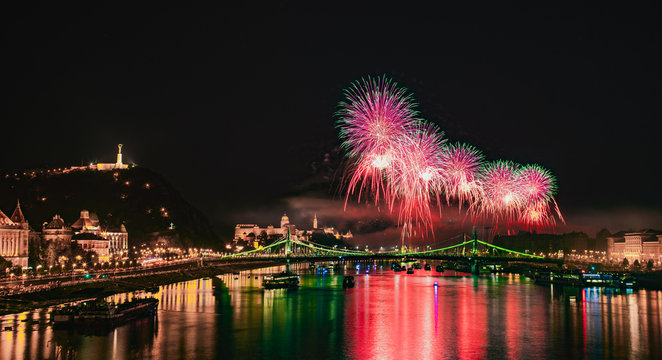 Colorful red fireworks over Budapest, River Danube with bridges, Gell&eacute;rt hill, night