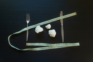 DIet concept - cauliflower wrapped with measuring tape