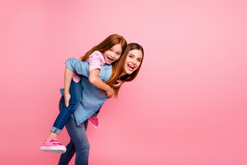 Funny foxy little lady and her mom spending weekend together wear casual clothes isolated pink background
