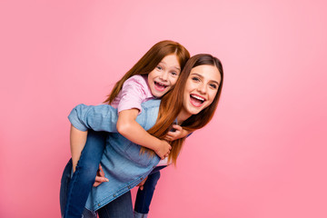 Pretty foxy little lady and her mom spending weekend together wear casual clothes isolated pink...